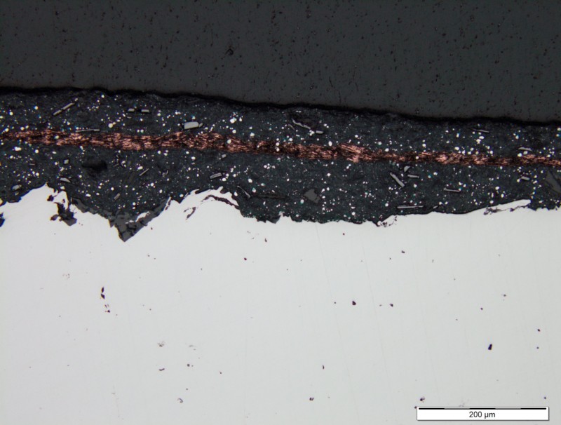 O mesmo teste foi feito com uma tinta típica “rica em zinco”. O filme de cobrepermanece intacto entre as duas camadas, o que demonstra que elas permanecem como camadas separadas.